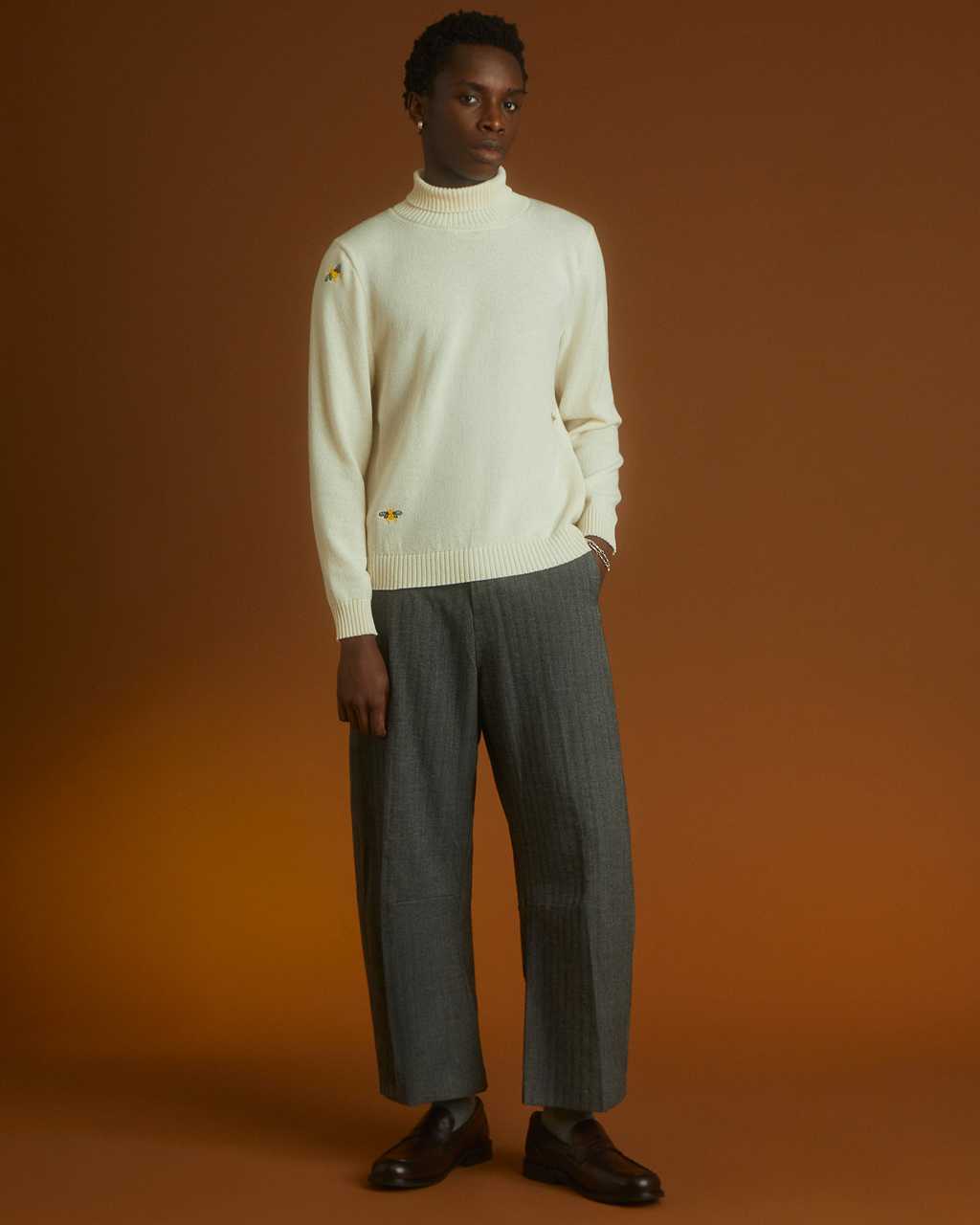 Men wearing a INGMARSON embroidered rollneck jumper