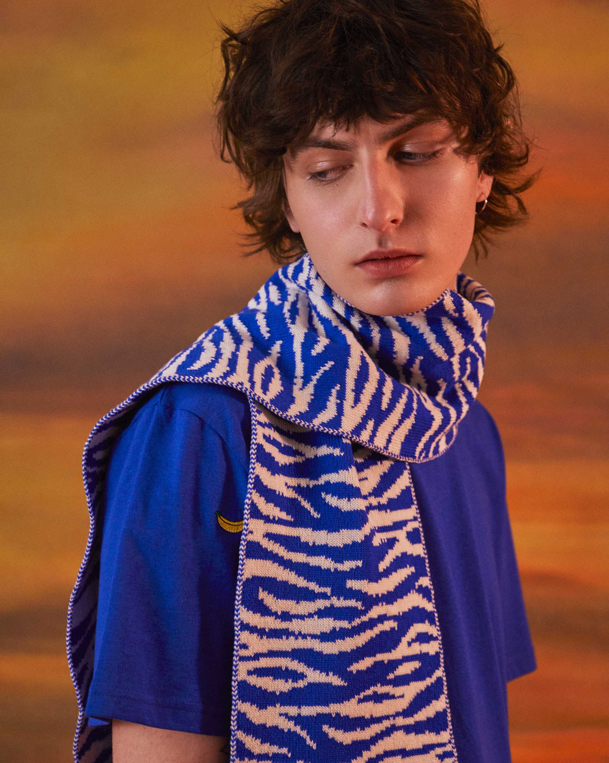Tiger patterned blue knitted scarf on a male model